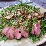 Barbecued butterflied lamb with roast peppers and pistachio pesto